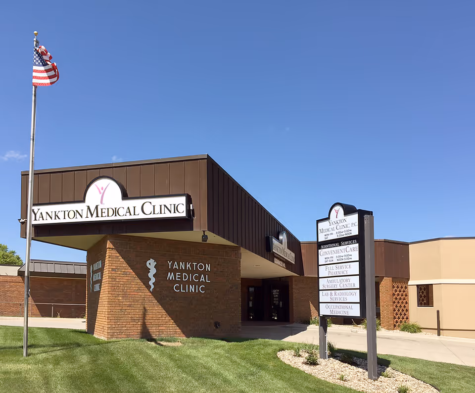Exterior view of Yankton Medical Clinic building with flagpole and sign.