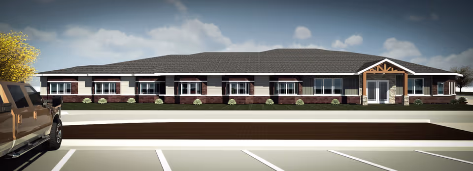 Single-story brick senior living facility with a parking lot and front entrance.