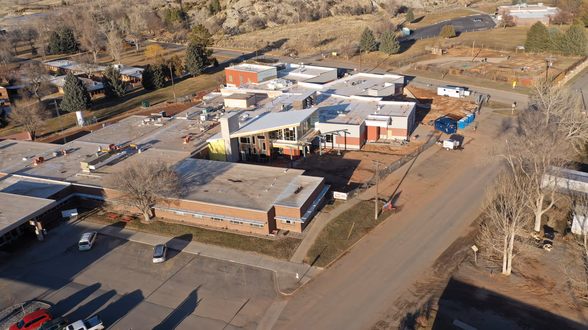 Aerial view of a low, flat-roofed senior living campus with parking.