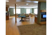 Interior common area at Park Place Assisted Living with sofas, tables, and windows.