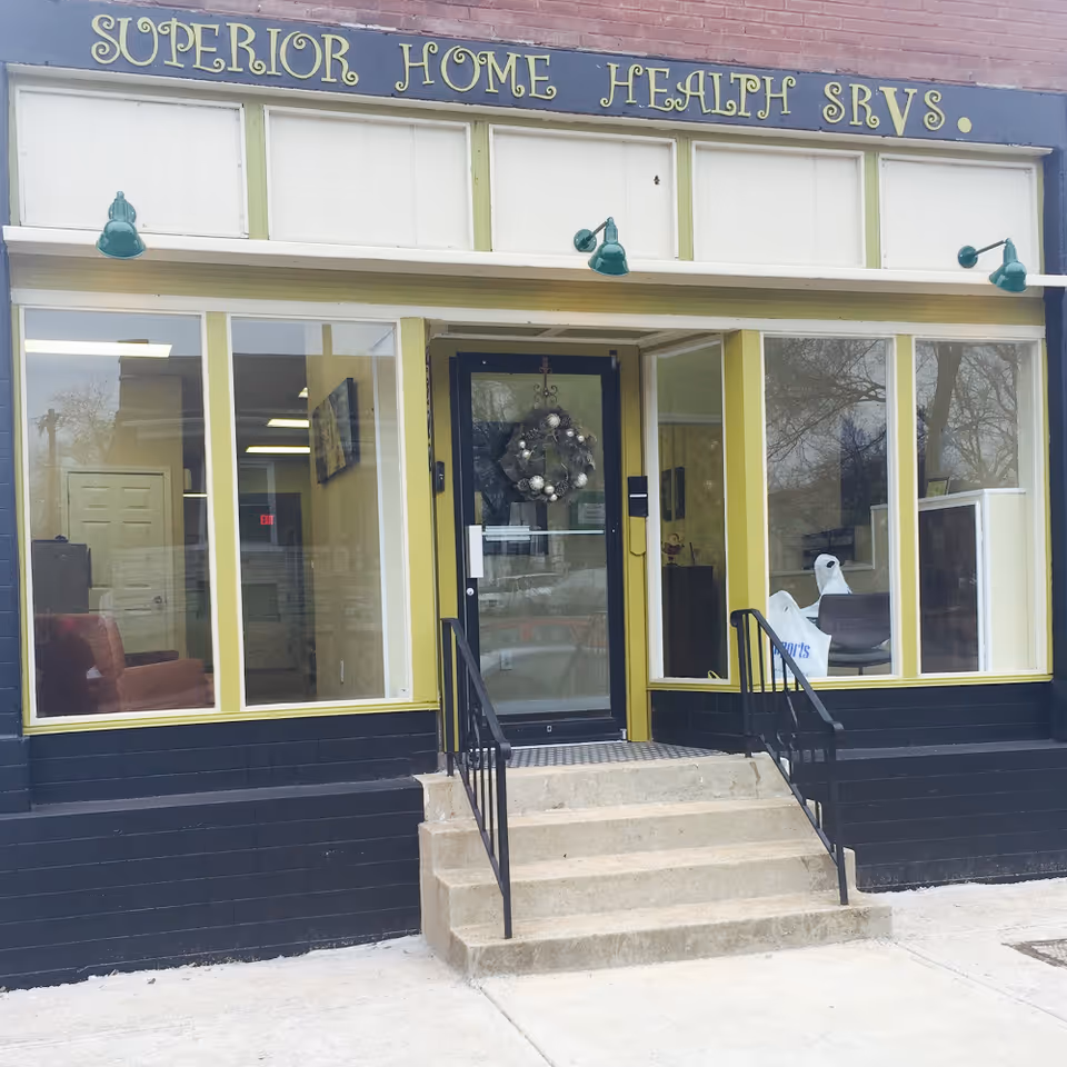 Exterior of Superior Home Health Services storefront with large windows and stairs.