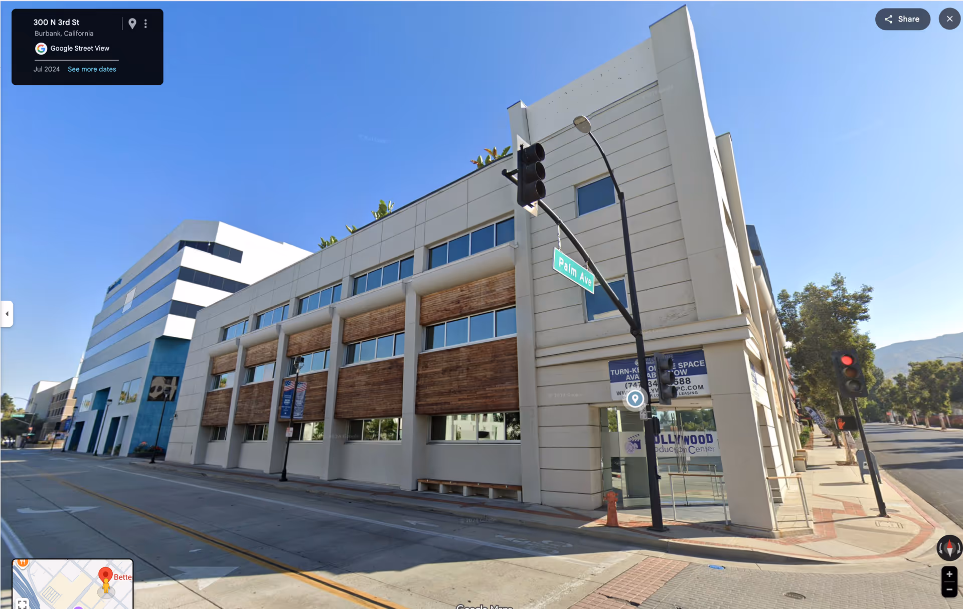 Exterior street-view of a modern corner building with large windows.