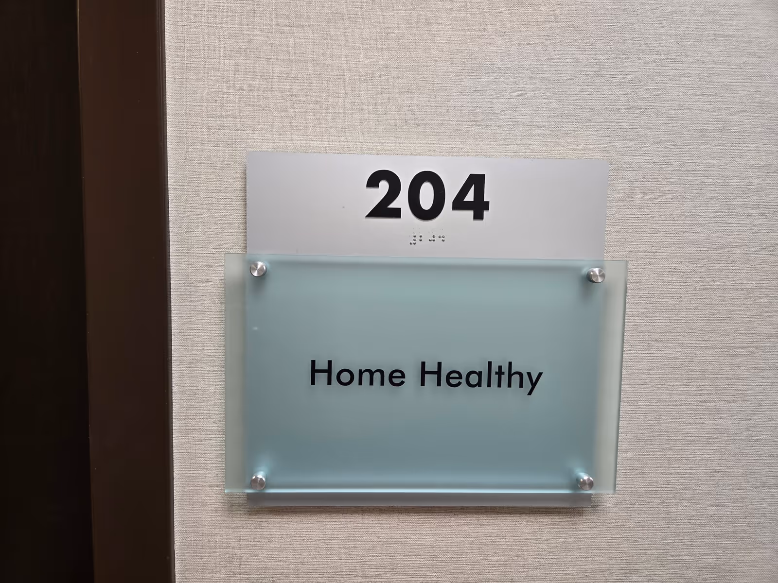 Interior wall shows room number 204 and a frosted glass sign reading Home Healthy.