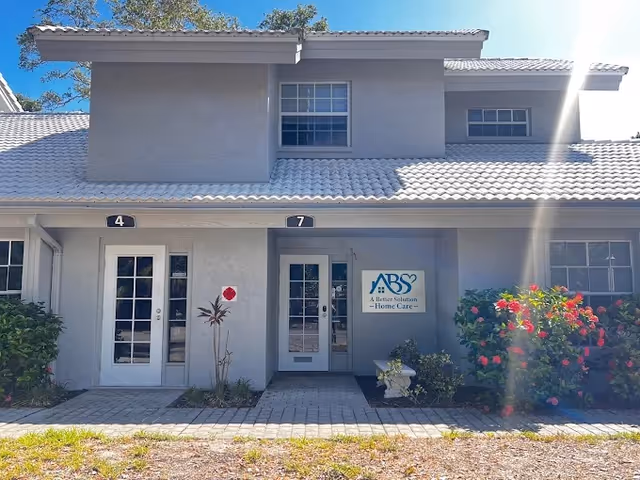 Front exterior of A Better Solution Home Care facility with doors and landscaping.