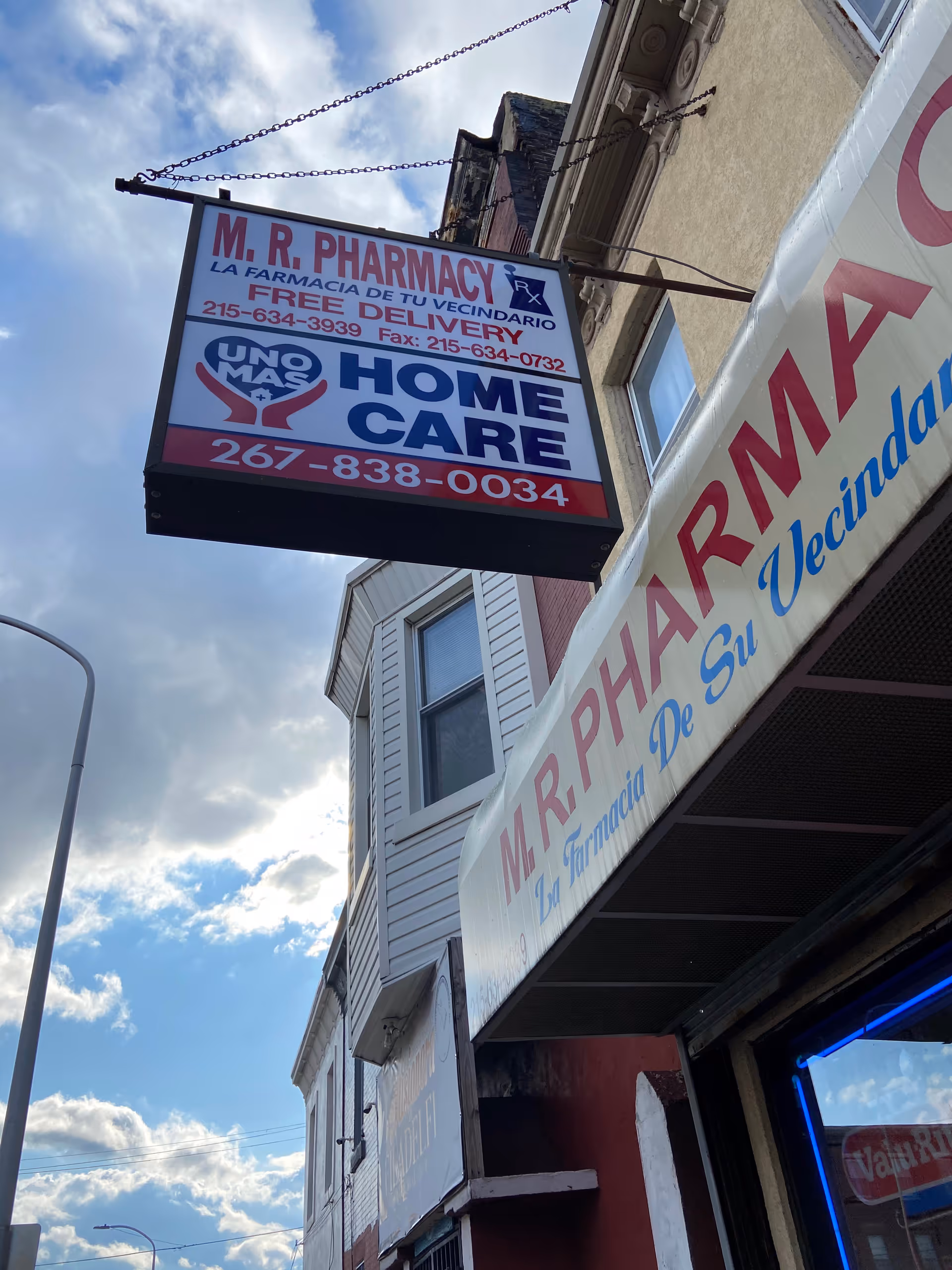View of Uno Mas Home Care LLC storefront signage on a building front beside a pharmacy.