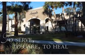Exterior view of Avante at Ocala with palm trees and arched entrance