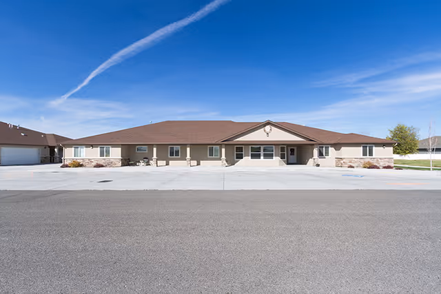 Ashley Manor Parkview Drive exterior with a wide parking lot and blue sky.