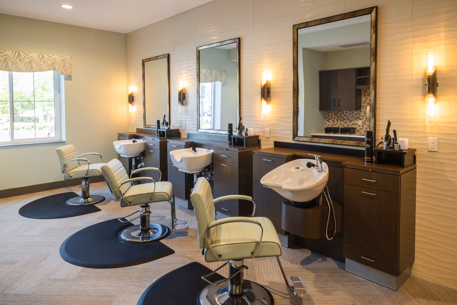 A bright salon-style interior with multiple shampoo stations, mirrors, and swivel styling chairs.
