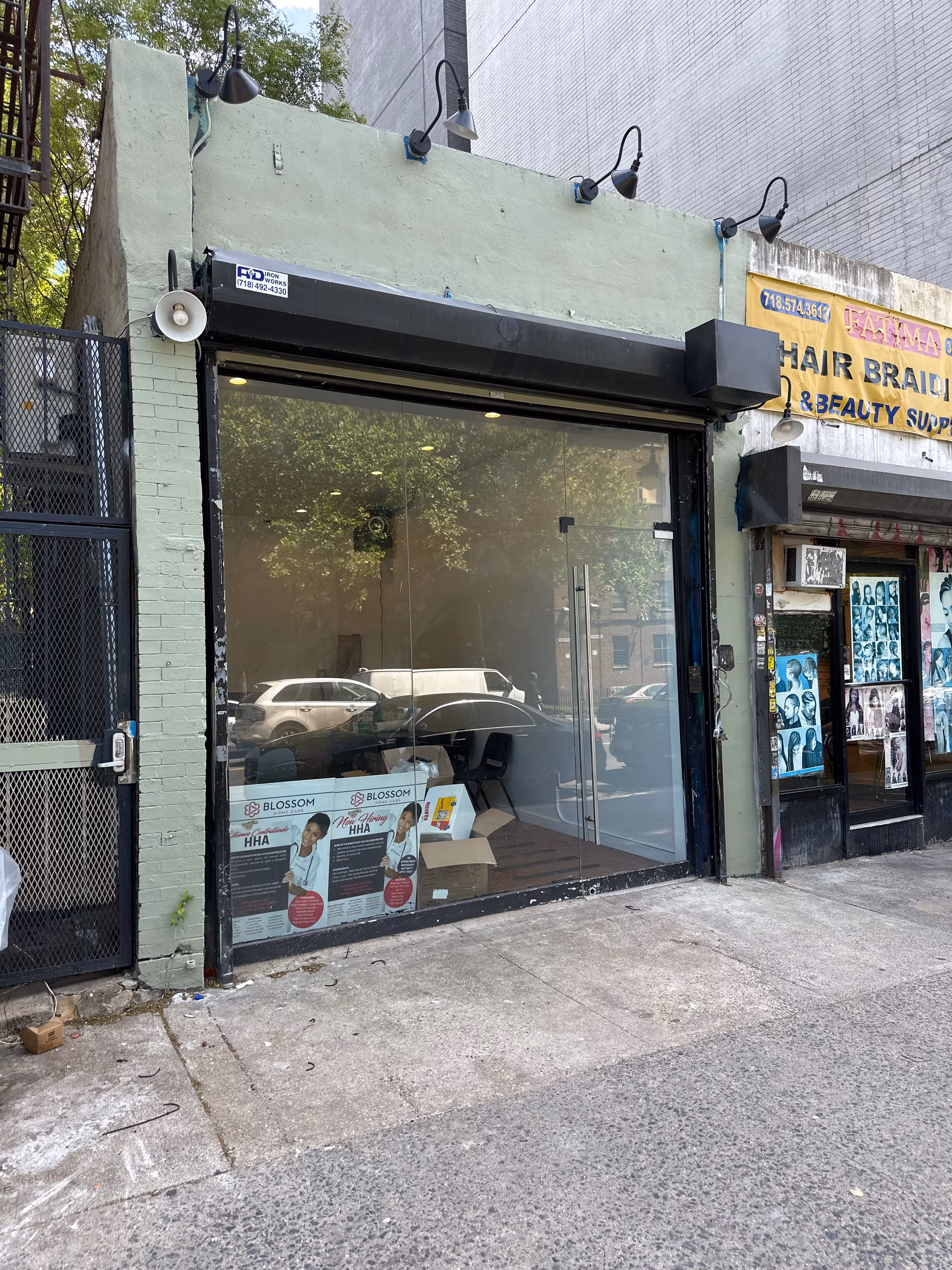 A street-level storefront with glass front and Blossom Home Care signage in Brooklyn.