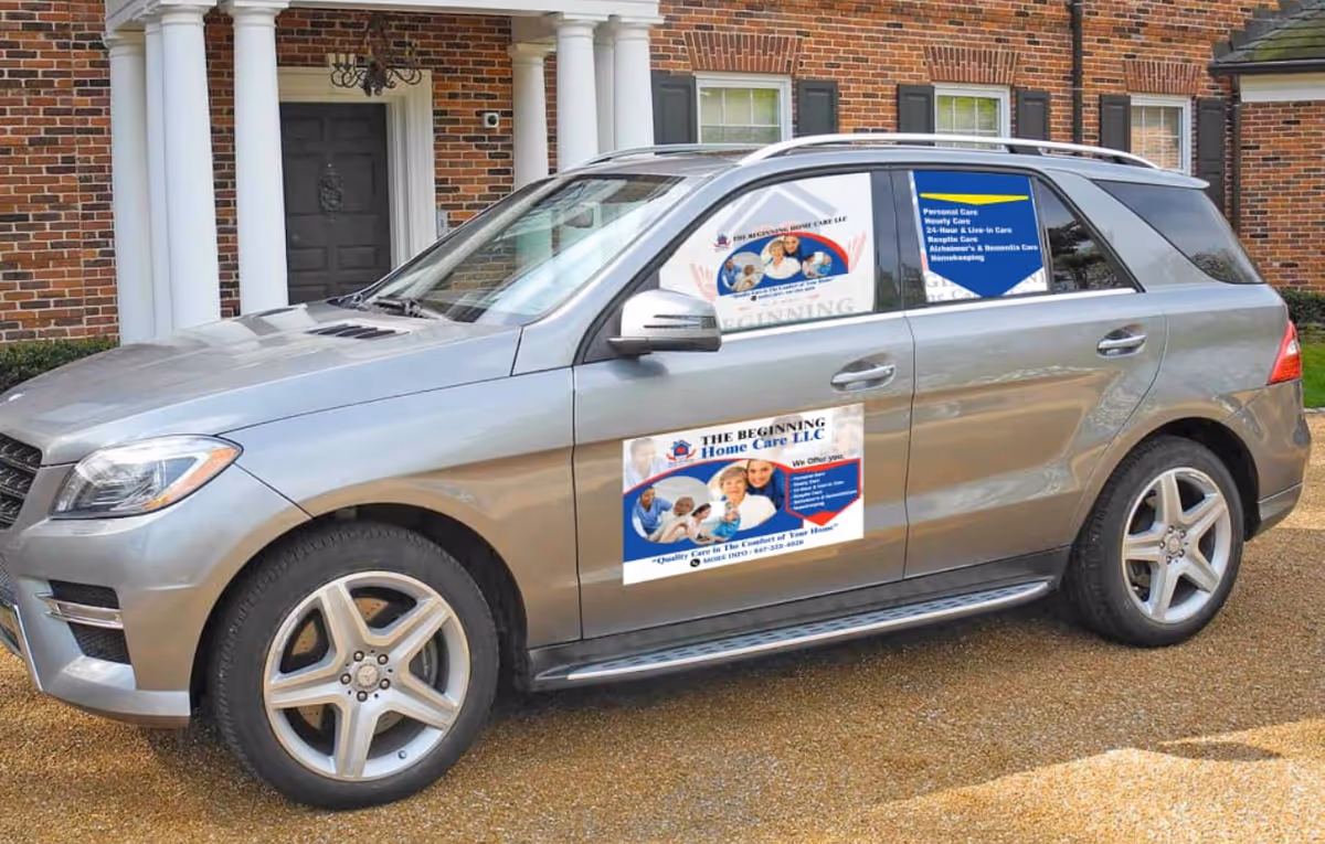 A silver SUV with The Beginning Home Care signage parked before a brick building.