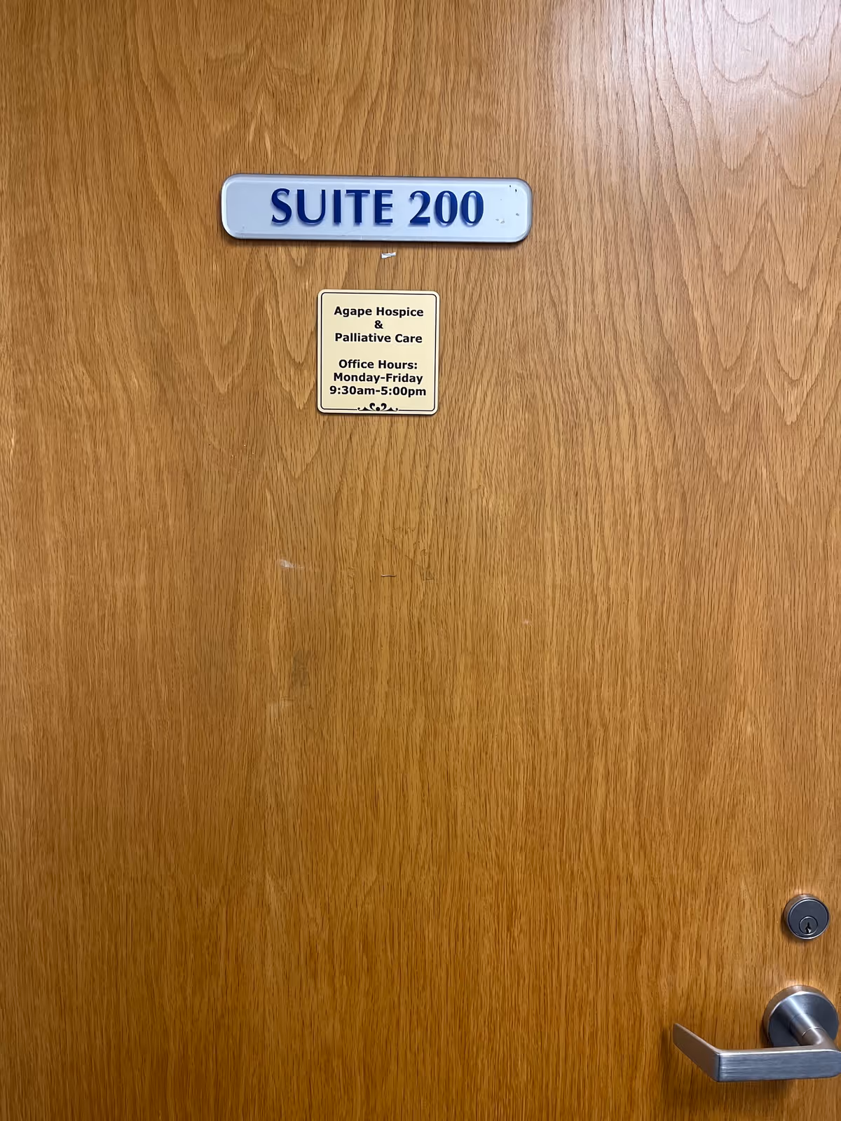 Wooden door labeled Suite 200 with a small Agape Hospice plaque.