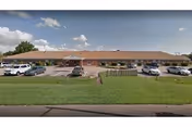 Norris senior living facility exterior with a parking lot and blue sky.