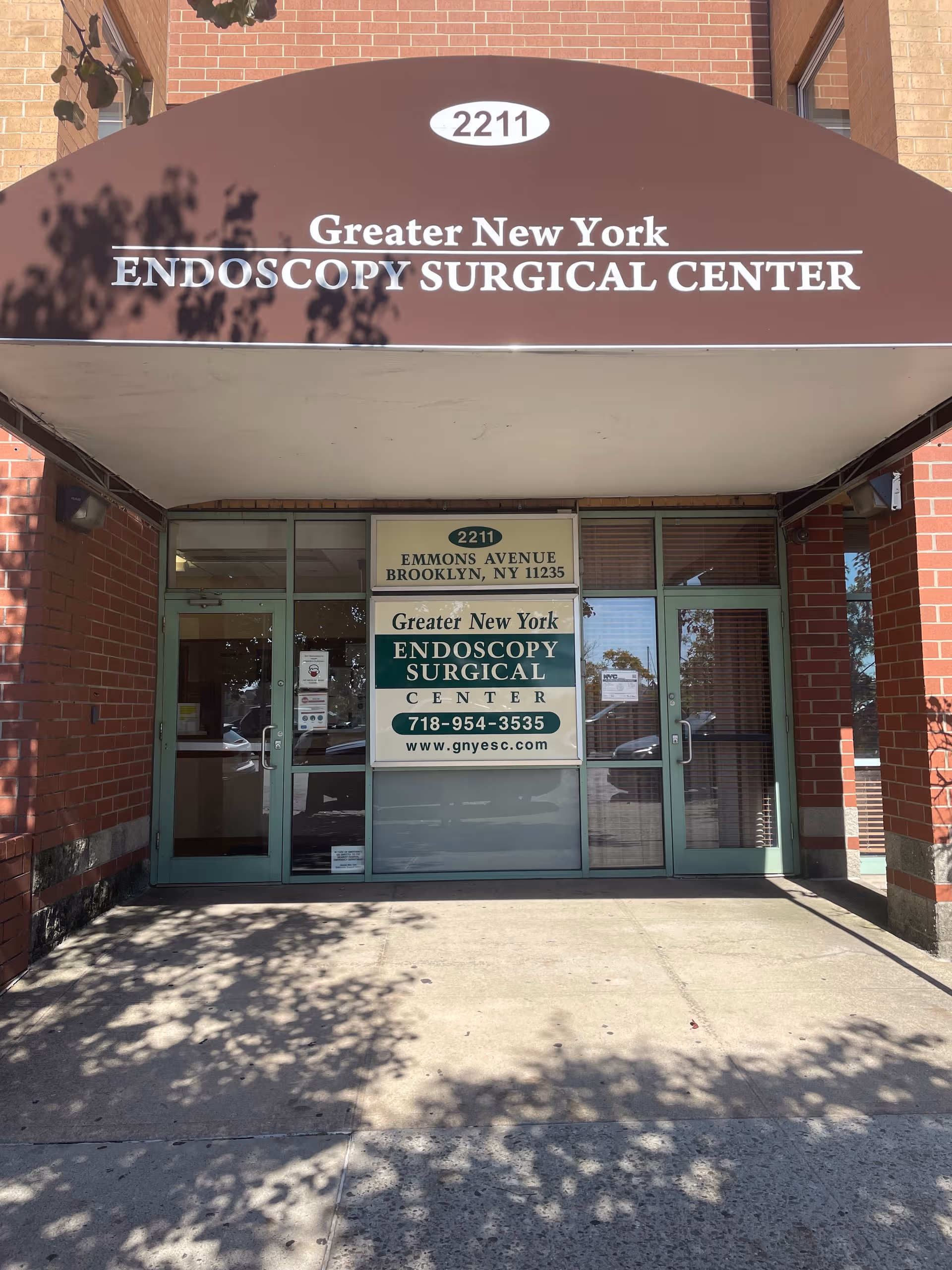 Front entrance of Greater New York Endoscopy Surgical Center under a brown canopy.