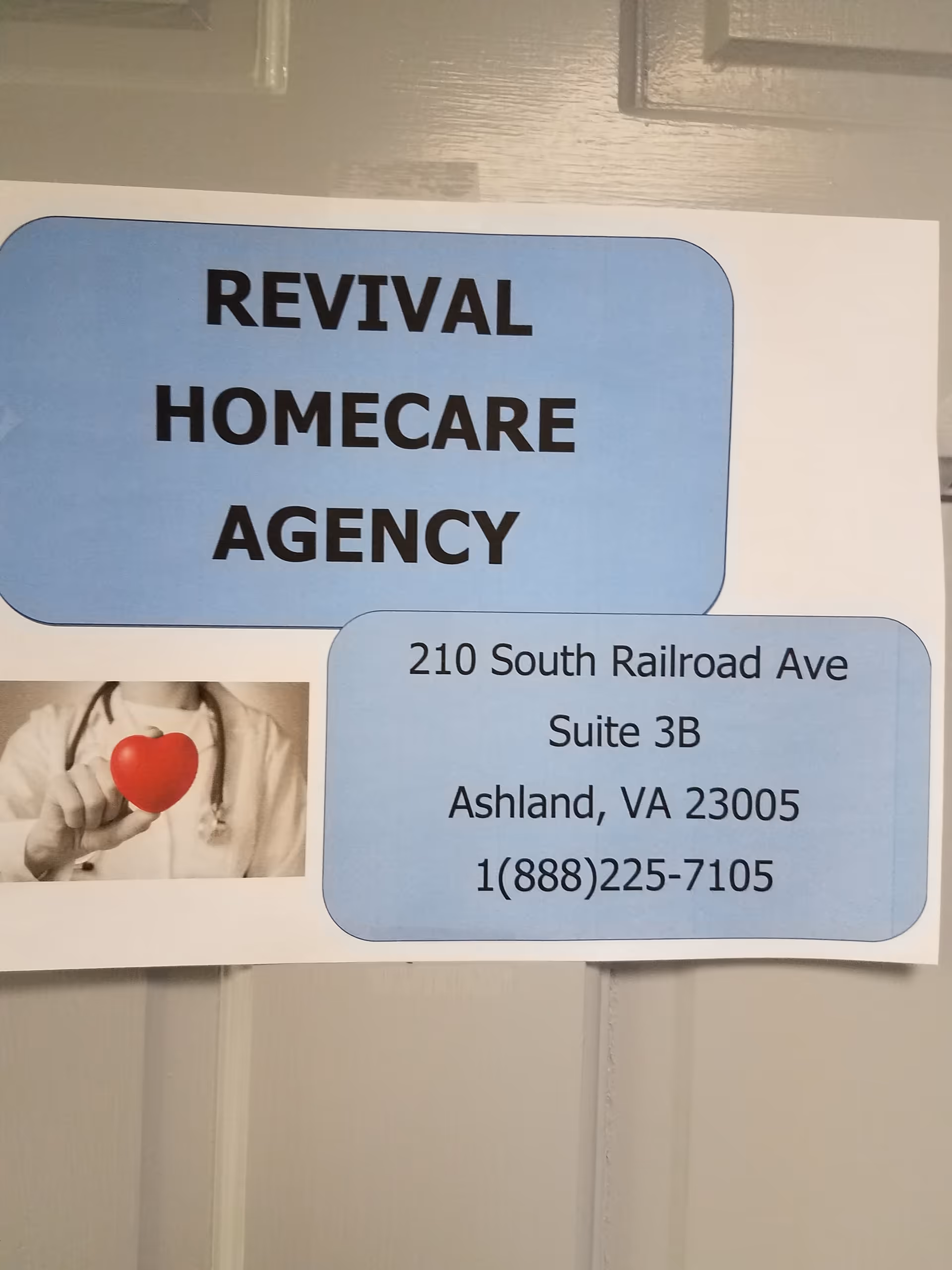 Blue Revival Homecare Agency sign with address and a hand holding a red heart