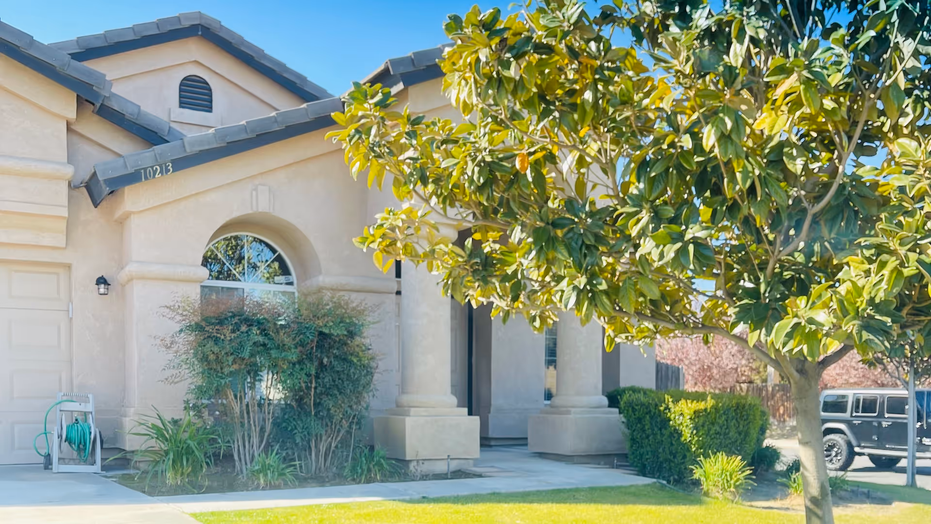 Exterior view of Lerwick Home Care building with arched doorway, columns, and trees.