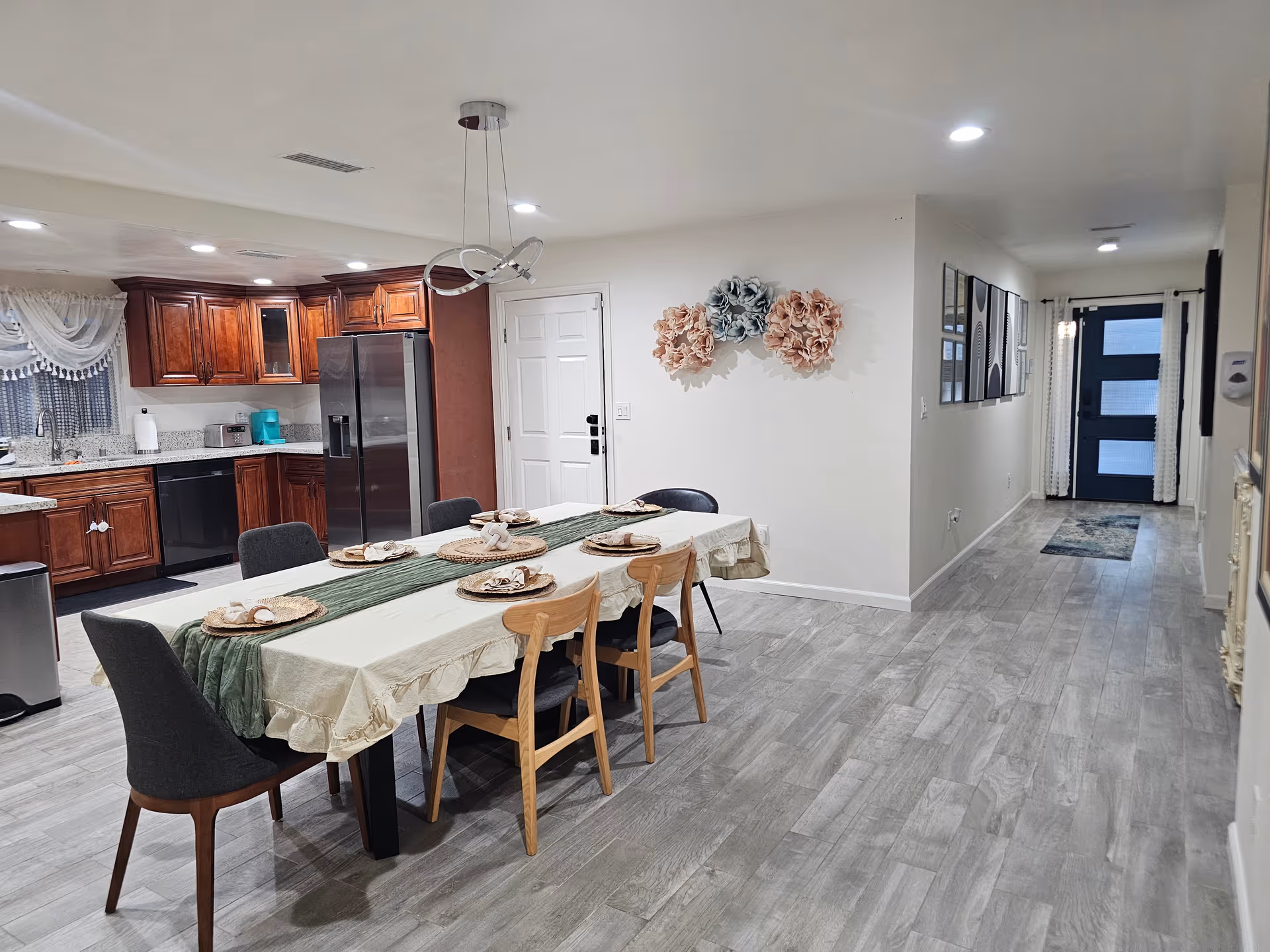 Long dining table set for a meal in a residential senior living dining area.