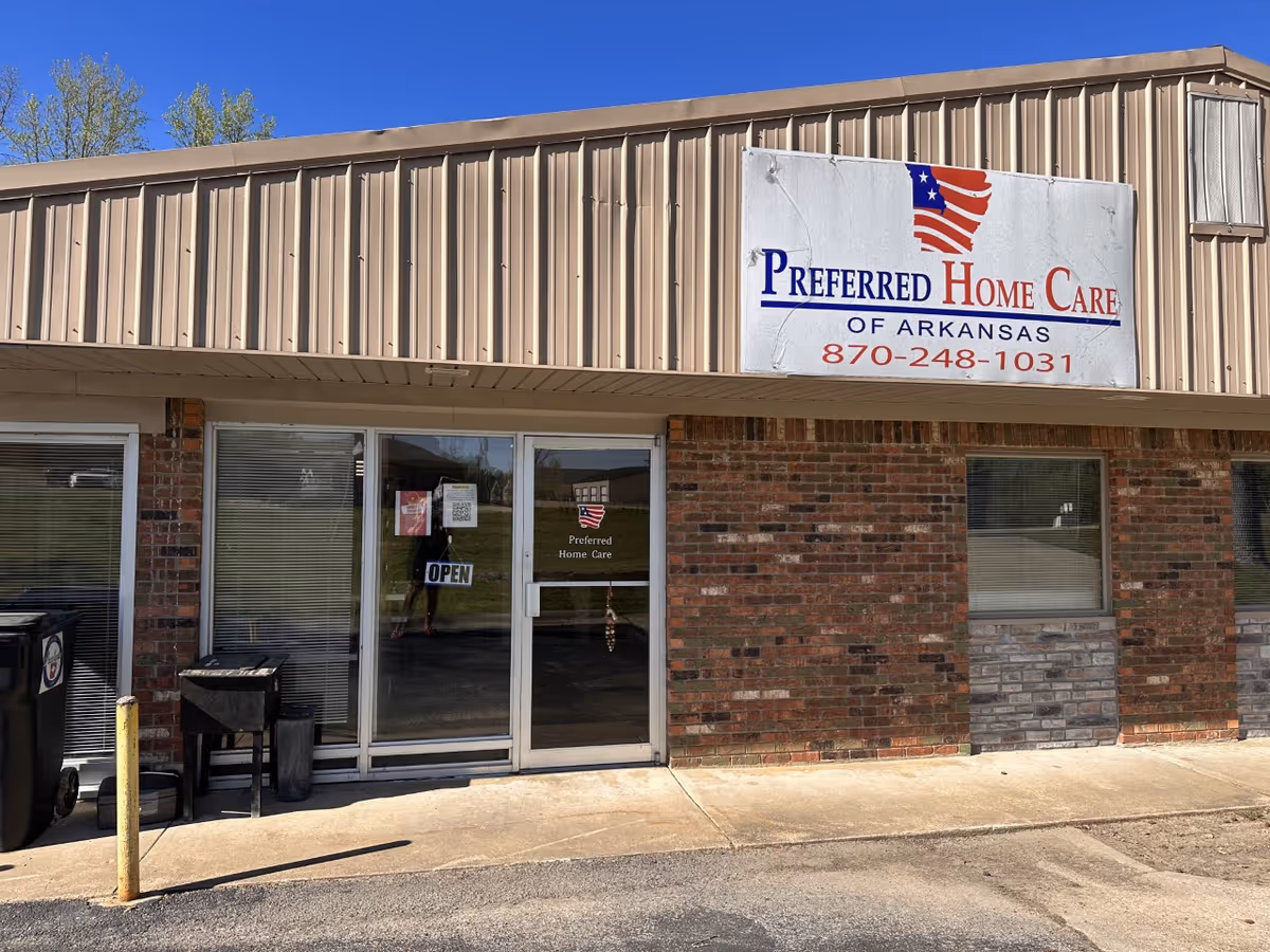Exterior view of a brick building with a large Preferred Home Care sign.