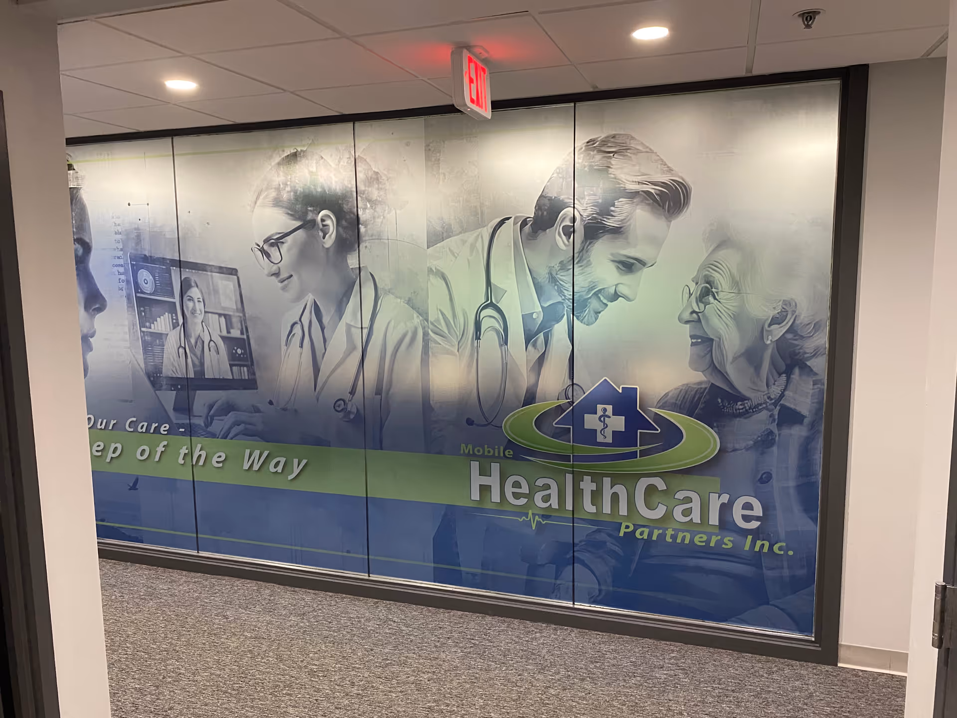 Interior hallway with a large Healthcare Partners mural of doctors and an elderly patient.