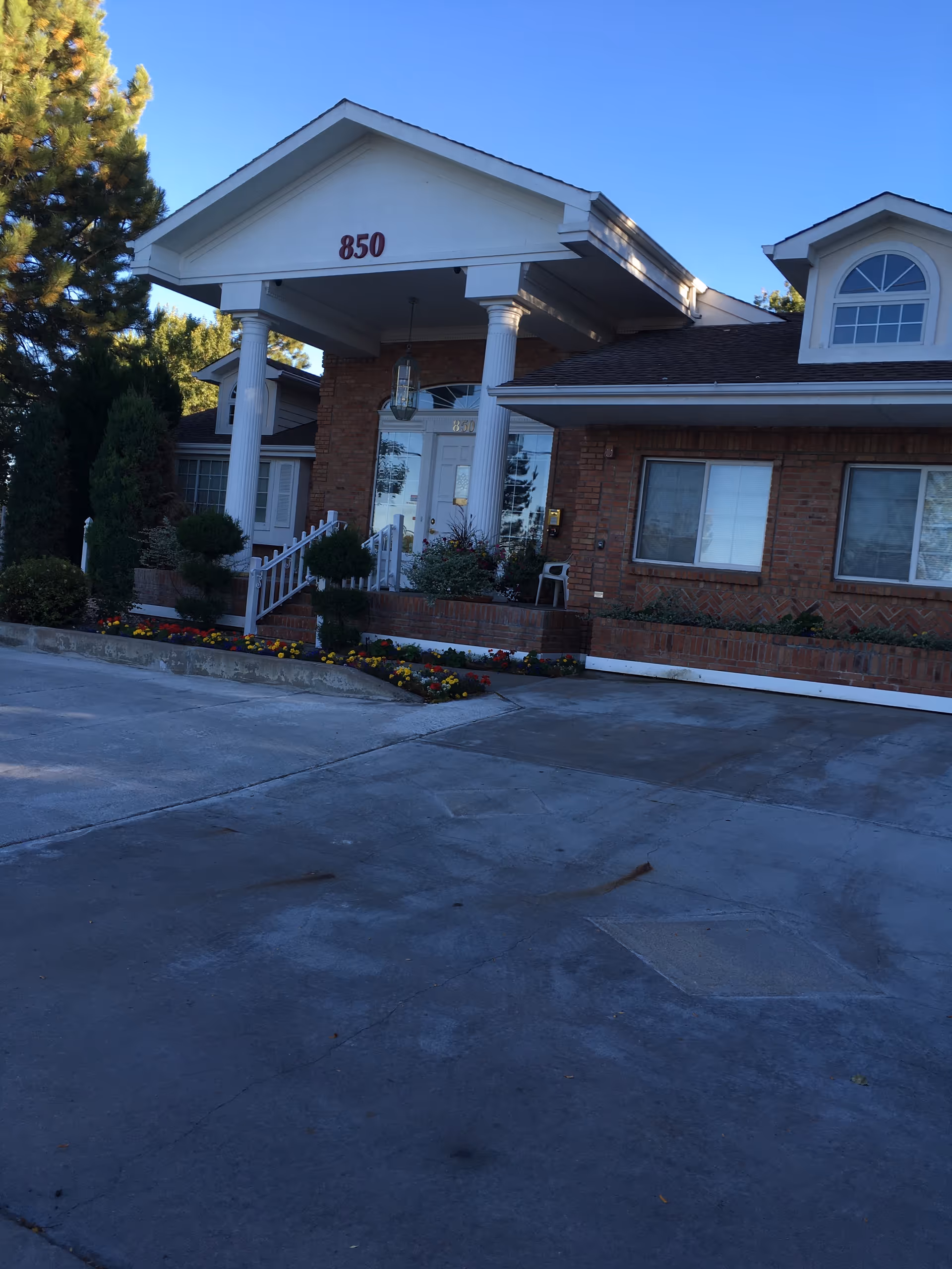 Exterior view of a brick Golden Orchard I and II senior living facility entrance with columns.