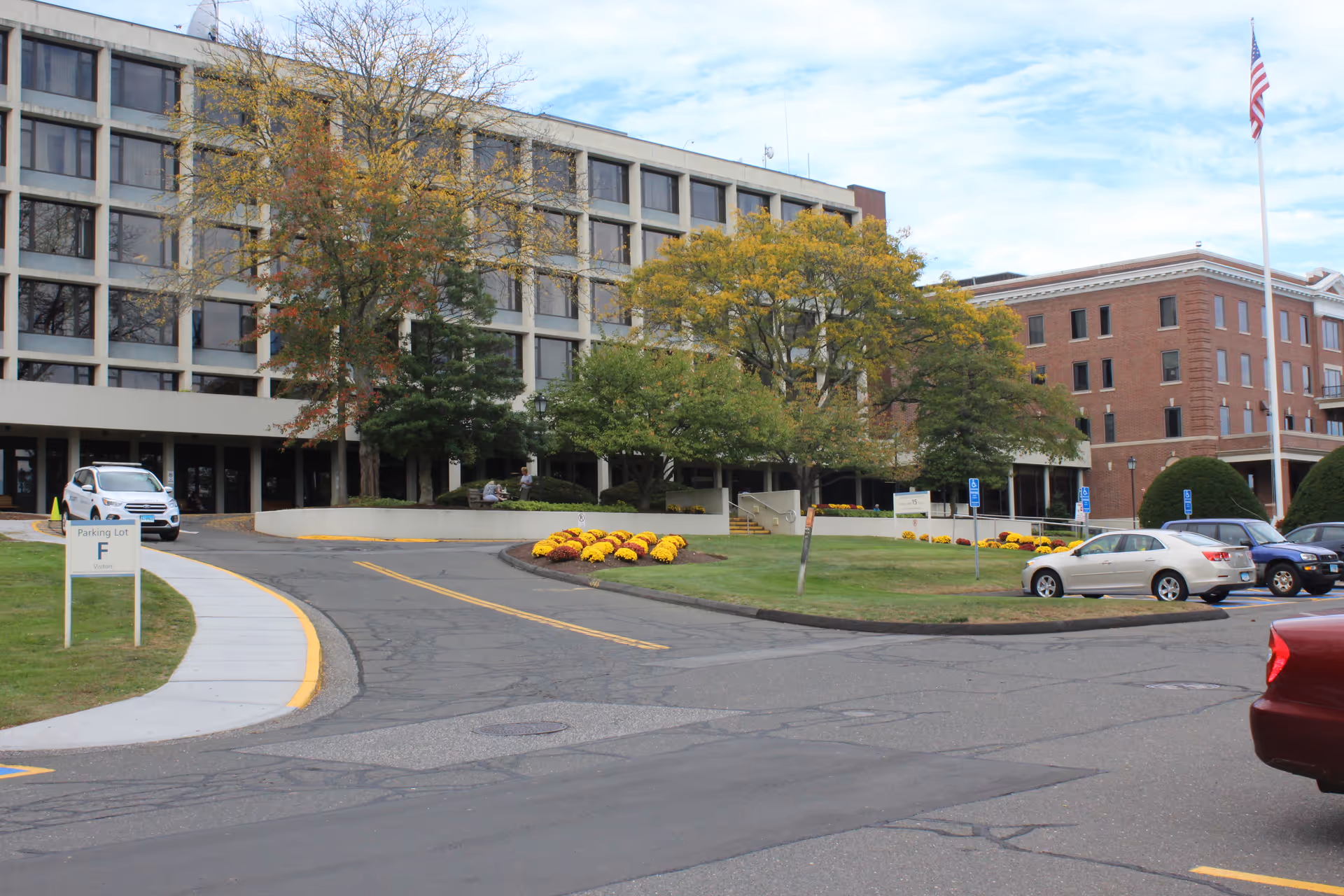 Exterior view of Masonicare Health Center with parked cars and landscaped entrance