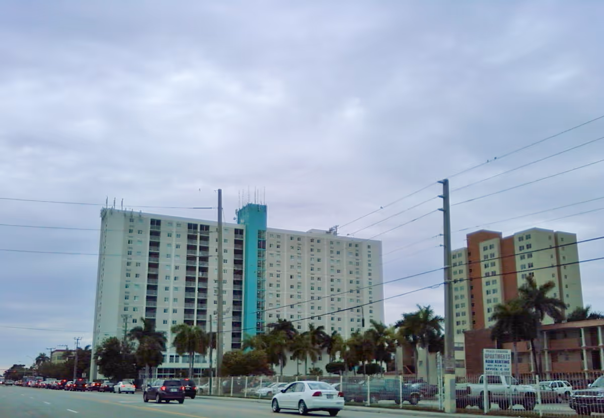 Exterior view of Residential Plaza at Blue Lagoon with tall buildings, palm trees, and a street.