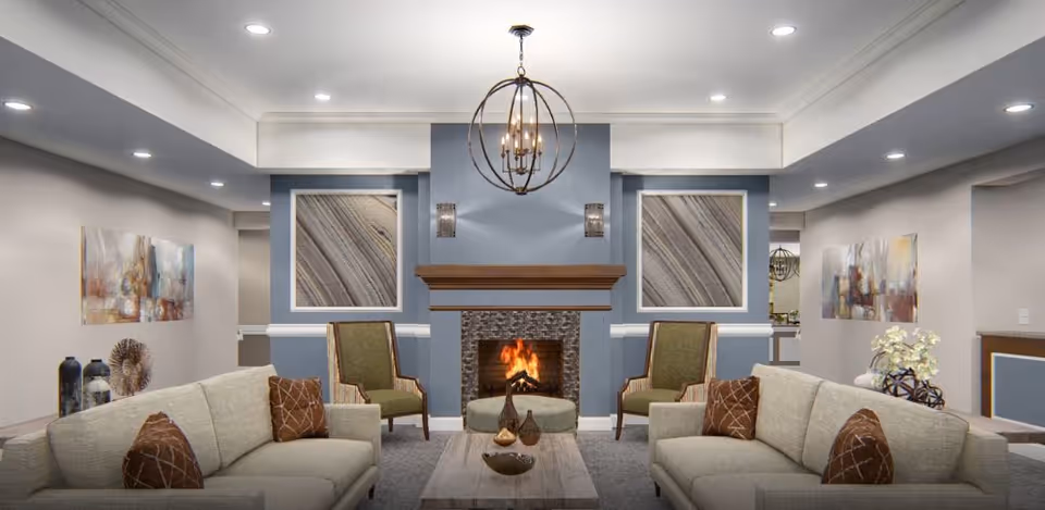 Elegant senior living lounge with fireplace, blue accent walls, seating, and artwork.