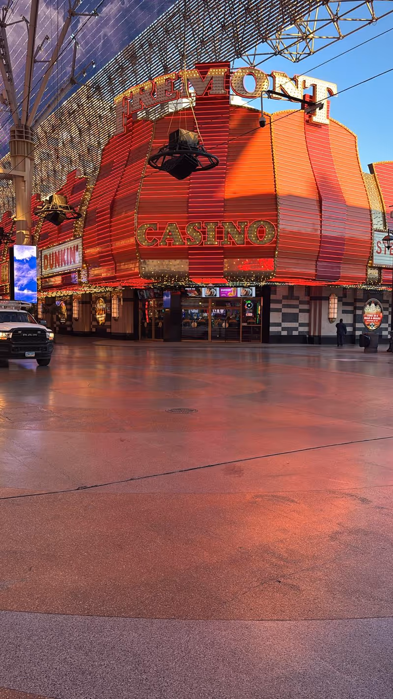 Exterior view of the Fremont Casino building with bright red neon signage.