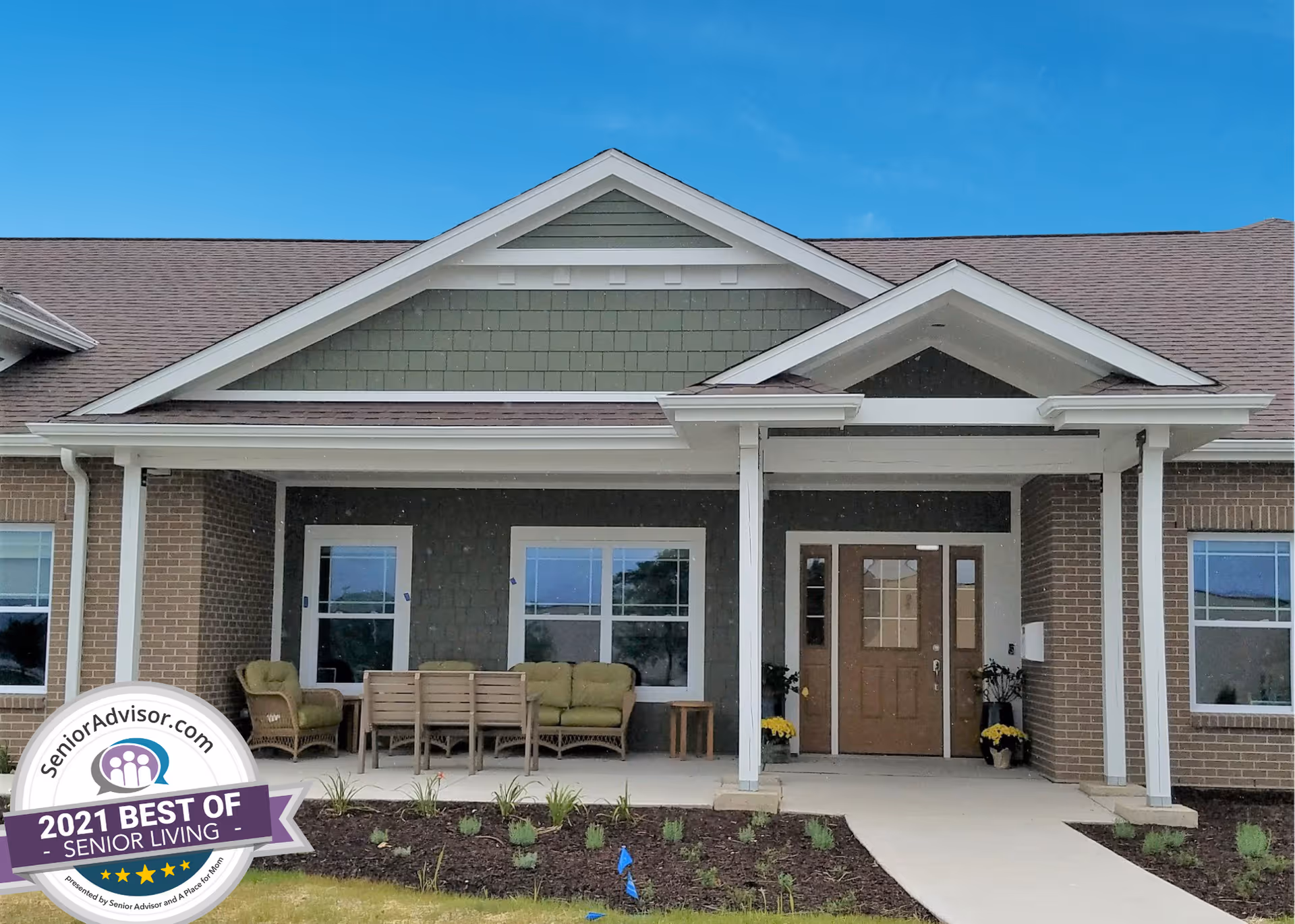 Front view of Azura Memory Care of Oak Creek II building with covered porch and seating.