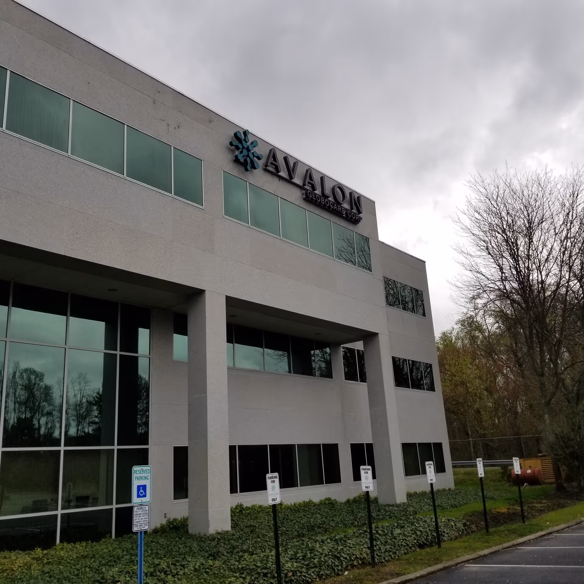 Exterior view of a modern gray building with large windows and Avalon signage.