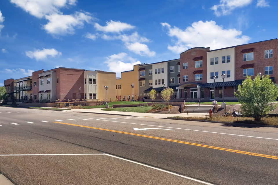 Exterior view of Castle Peak Senior Life and Rehabilitation campus along a busy street.