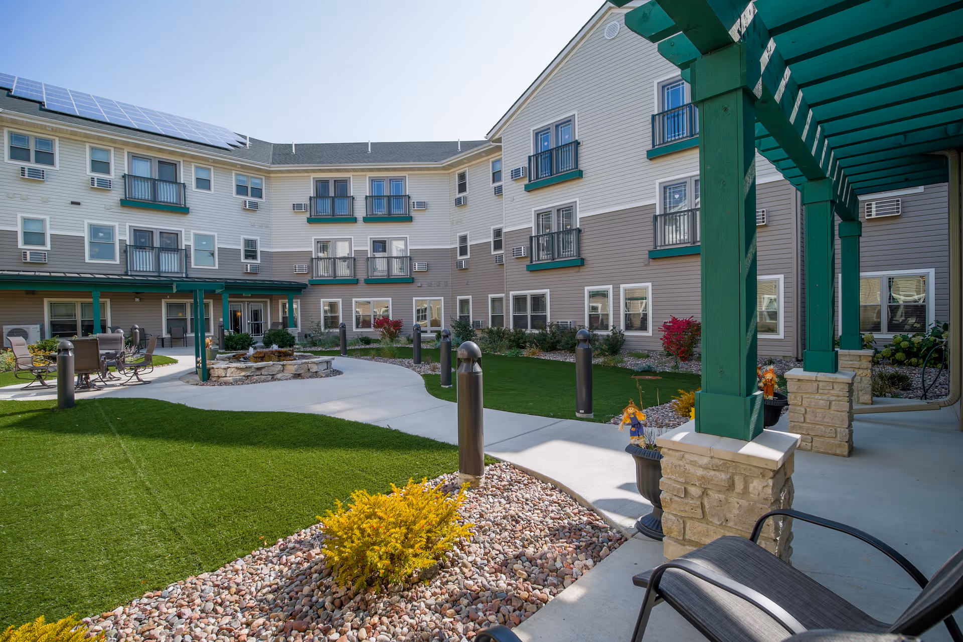 Sunny courtyard at The Parkview II with seating and a multi-story residential building.