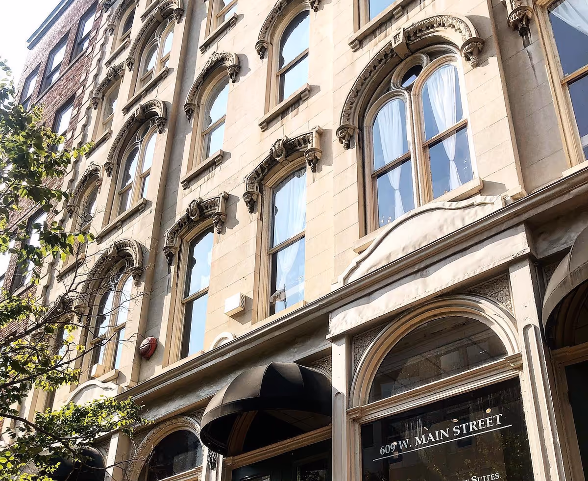 Storefront building with arched windows and ornate stonework.
