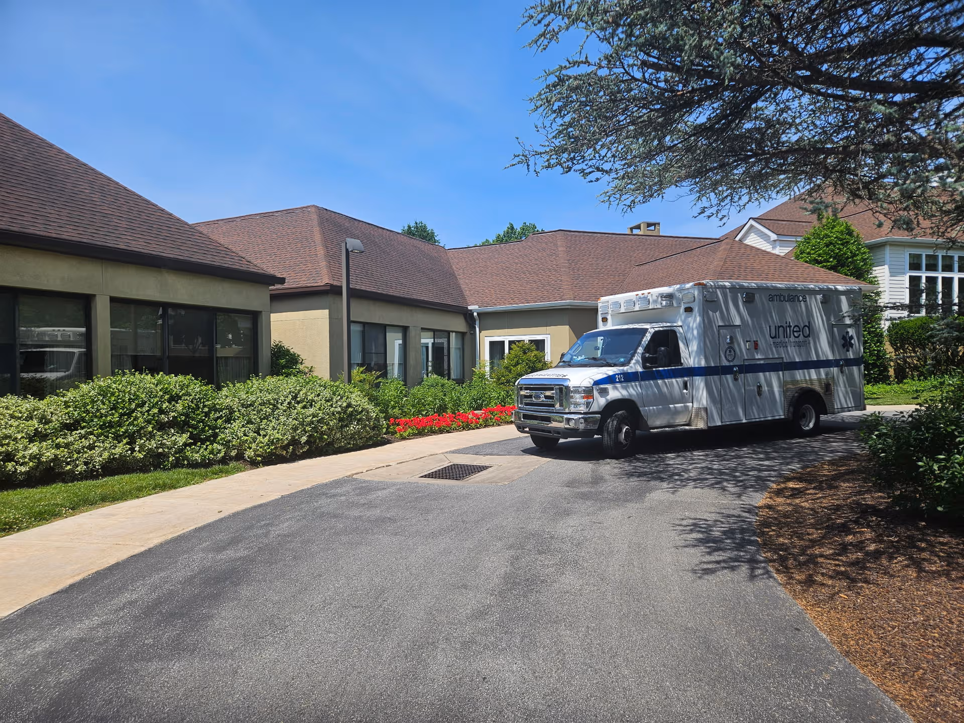 Exterior view of Dunwoody Village with an ambulance in front of the building.