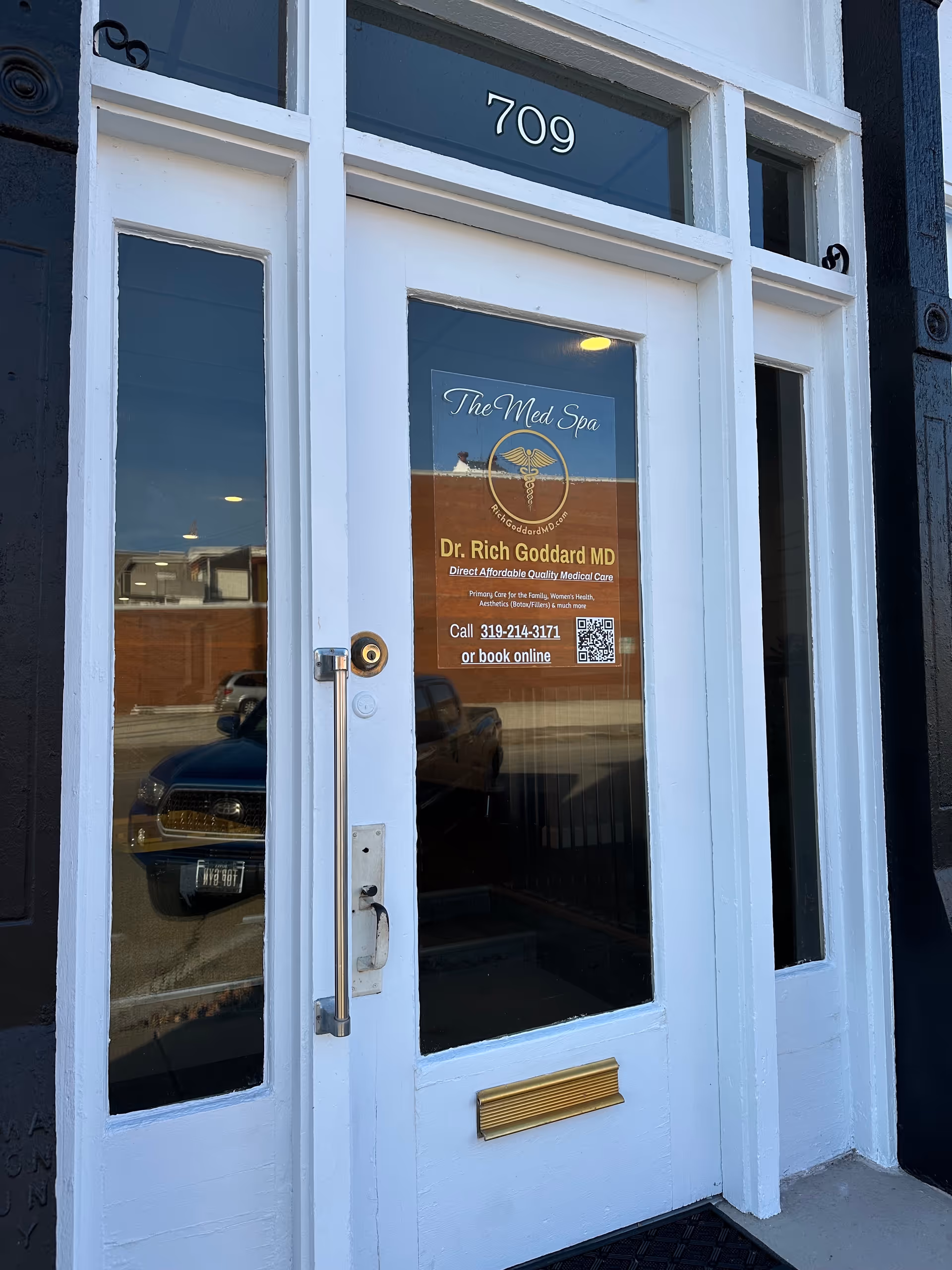 White entrance door with 709 above and The Med Spa sign on the glass
