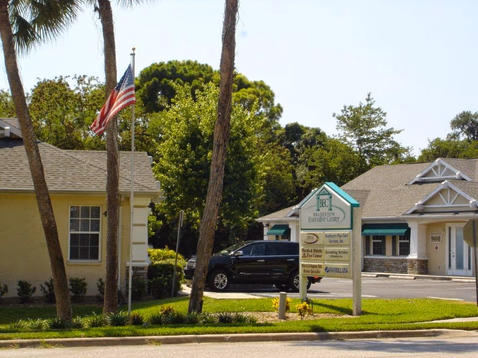 Front exterior of Granny Nannies Senior Home Care in Bradenton with a sign and American flag.