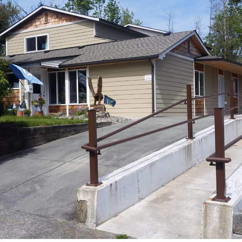 Exterior view of Mountlake Terrace AFH with ramp, entrance, and small decorations.
