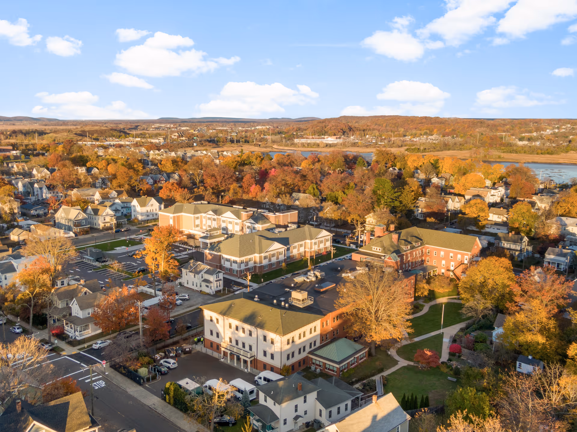 Aerial view of a fall-colored campus with buildings and trees.