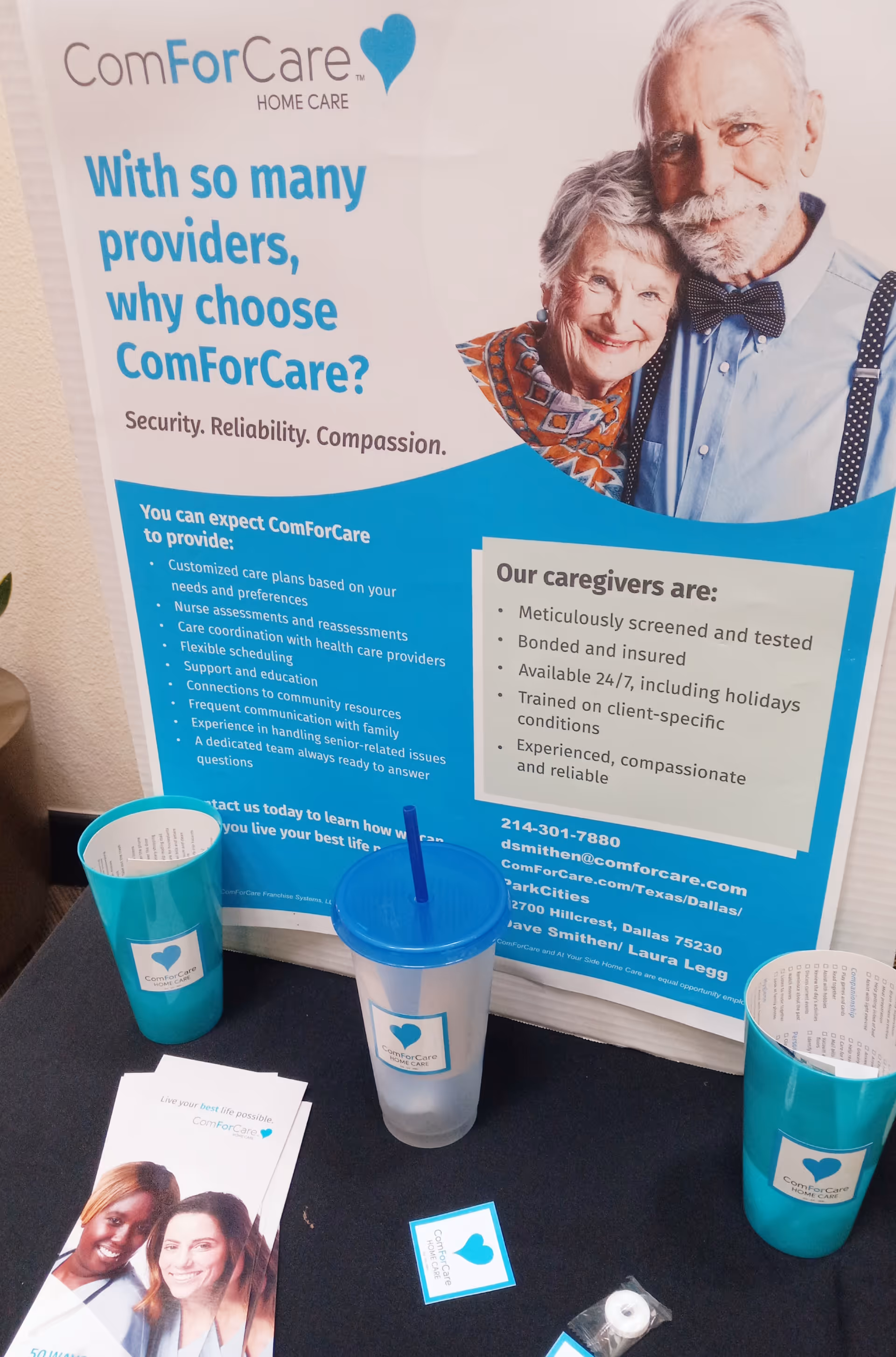 Poster advertising ComForCare Home Care with elderly couple on display, blue design, and cups on table.