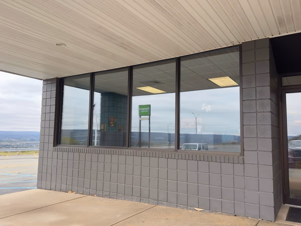 Exterior of a HireLivin Homecare LLC building with large windows.