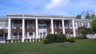 Front view of Parkview Rehabilitation Center at Winter Park with brick facade and columns.
