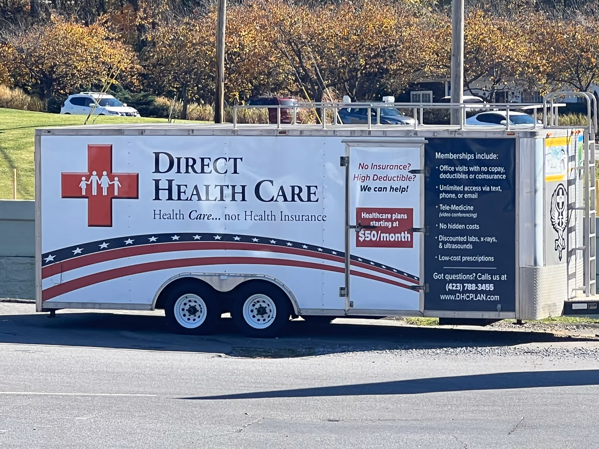 Promotional Direct Health Care trailer parked outdoors with large logo and text