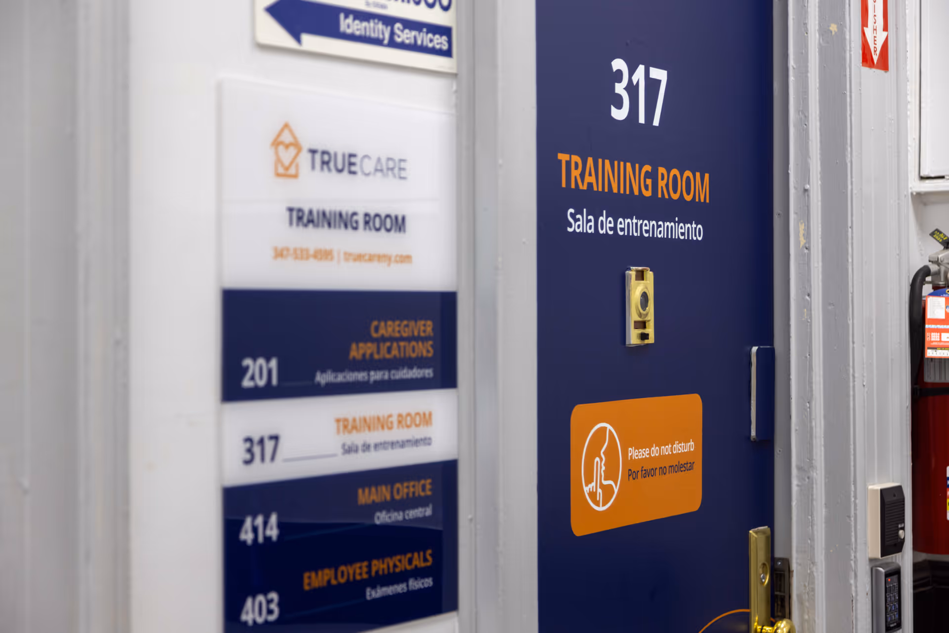 Blue door labeled Training Room with TrueCare signage and room directory.