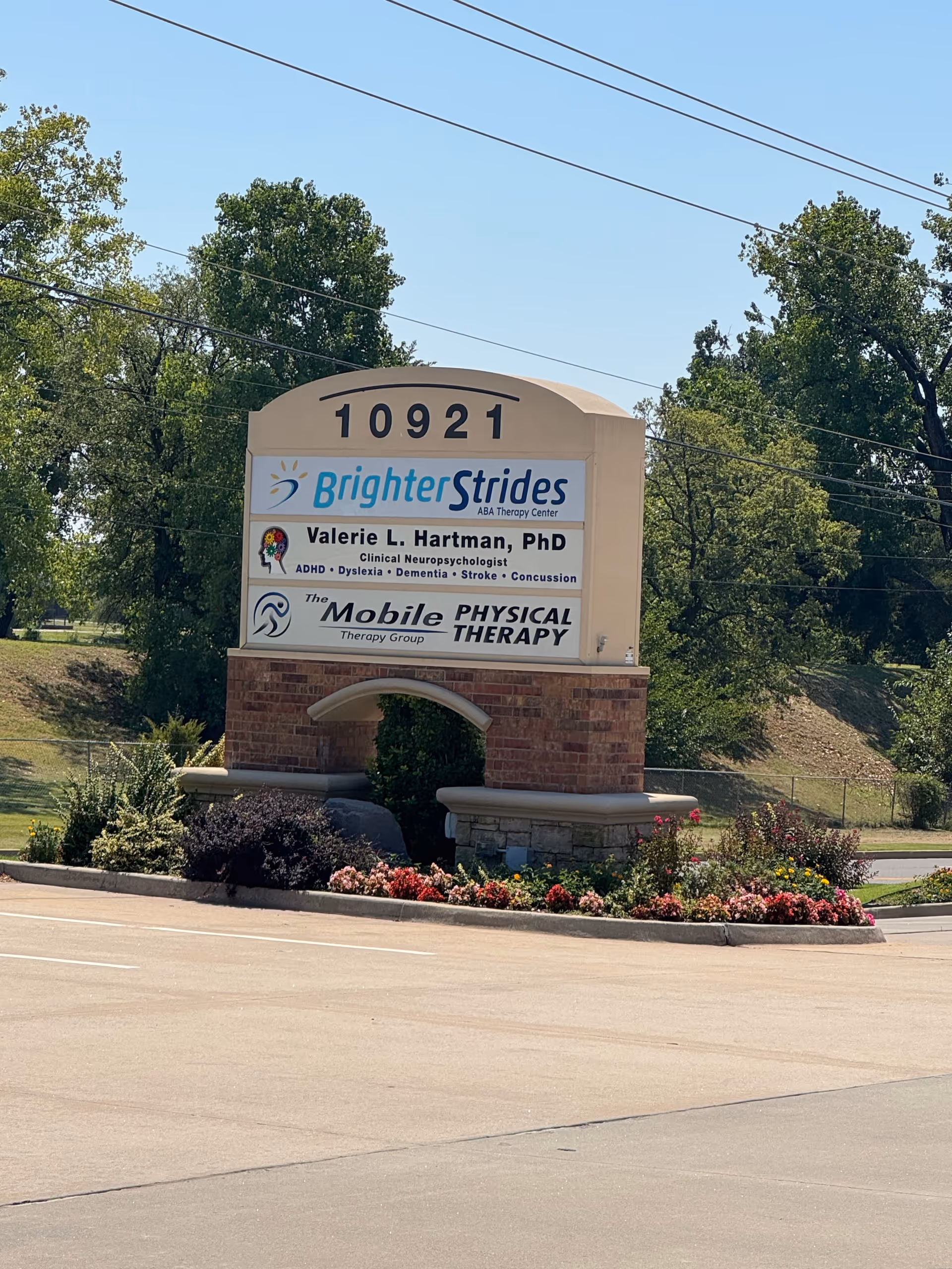 Front sign for Brighter Strides ABA Therapy Center at 10921 with landscaping