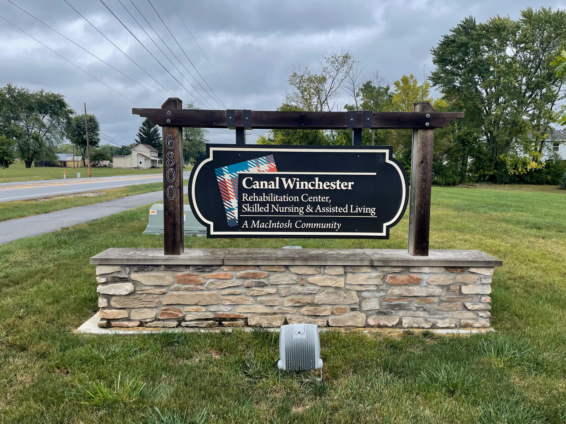Canal Winchester Rehabilitation Center sign mounted on stone base in grassy area.