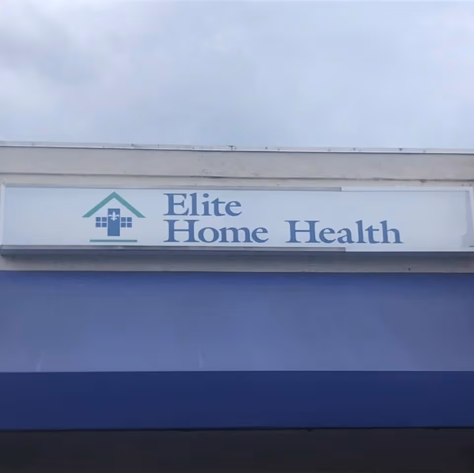 Exterior storefront sign showing Elite Home Health and teal logo on a light building.