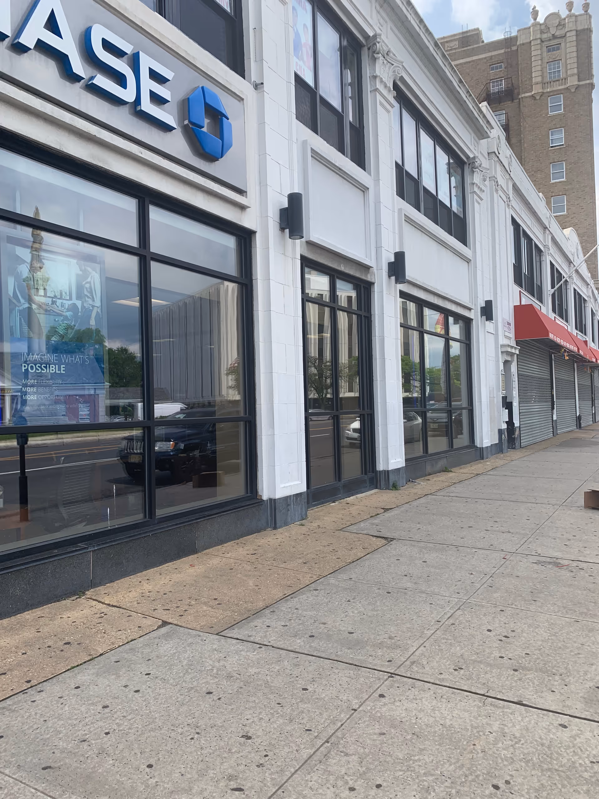 Exterior view of a glass-front storefront with large windows and a Chase sign.