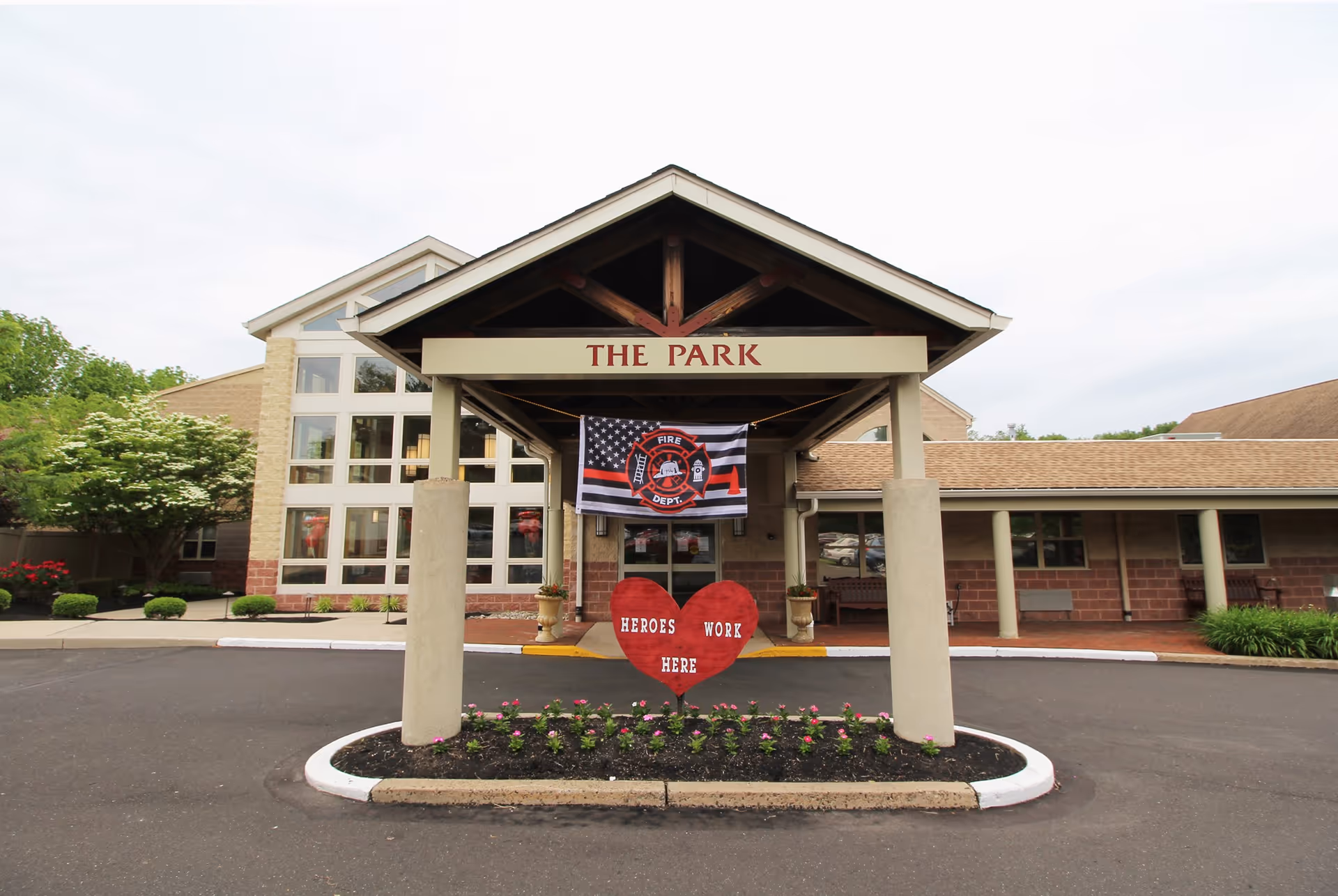 Exterior view of Gloria Dei Memory Care at the Park entrance with heart decor
