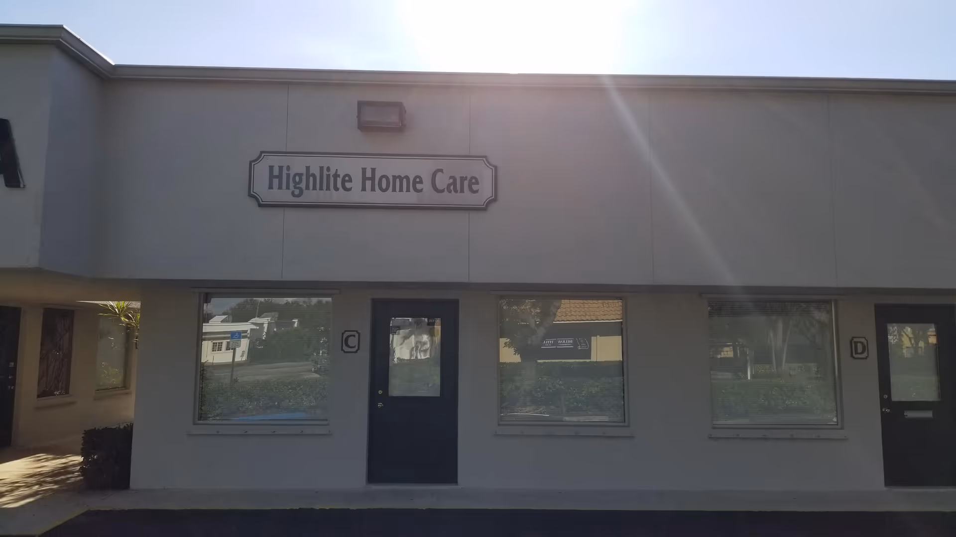 Exterior view of Highlite Home Care building with sign and two doors