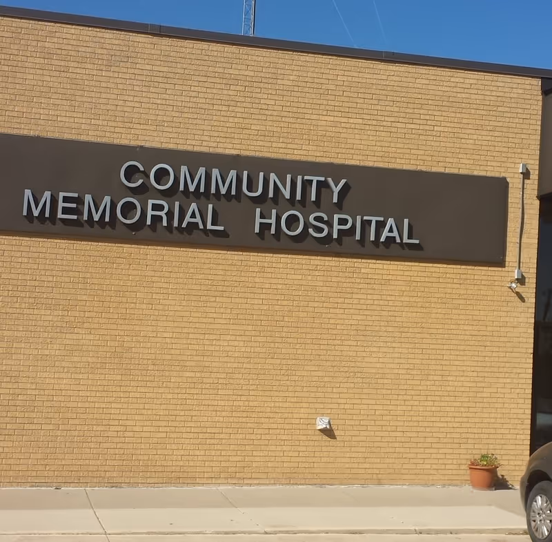 Exterior brick wall with a large sign reading Community Memorial Hospital