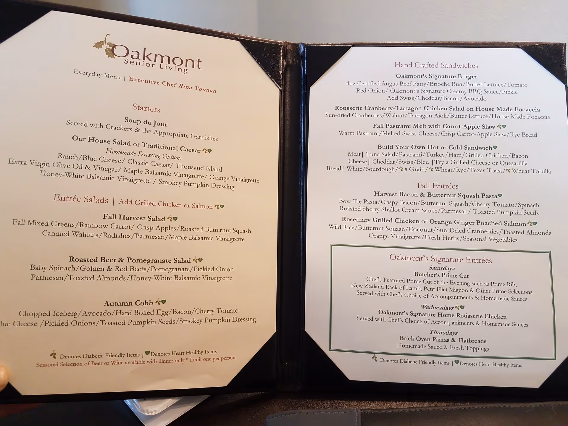 Oakmont Senior Living menu binder displaying starters, mains, and entrées.